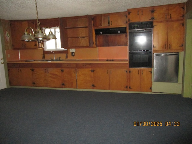 kitchen with sink, black appliances, a textured ceiling, decorative light fixtures, and exhaust hood