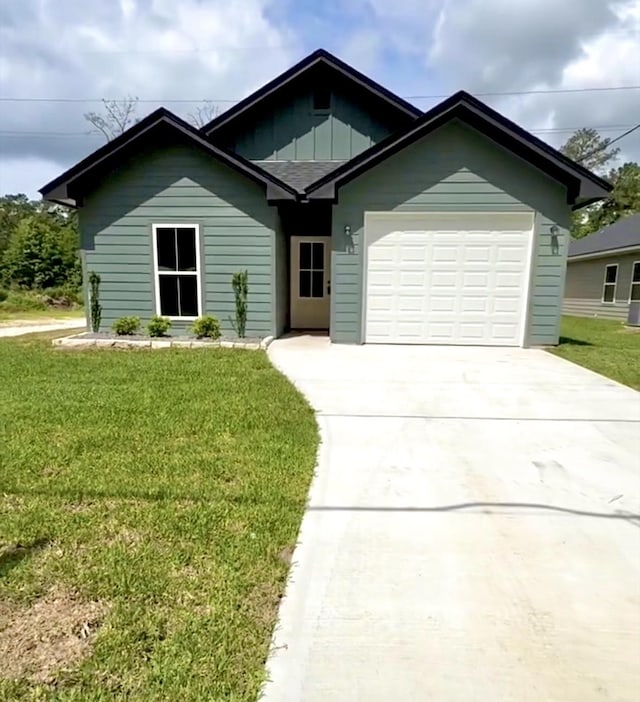 ranch-style house with a garage, board and batten siding, a front lawn, and driveway