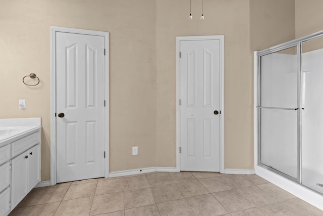 1424 Arbor Ct, Nederland, TX 77627 - bathroom featuring a shower stall, baseboards, and vanity
