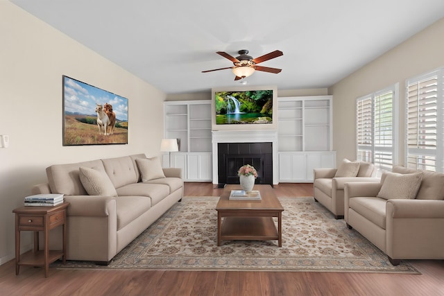 1424 Arbor Ct, Nederland, TX 77627 - living room featuring wood finished floors, ceiling fan, and a tiled fireplace