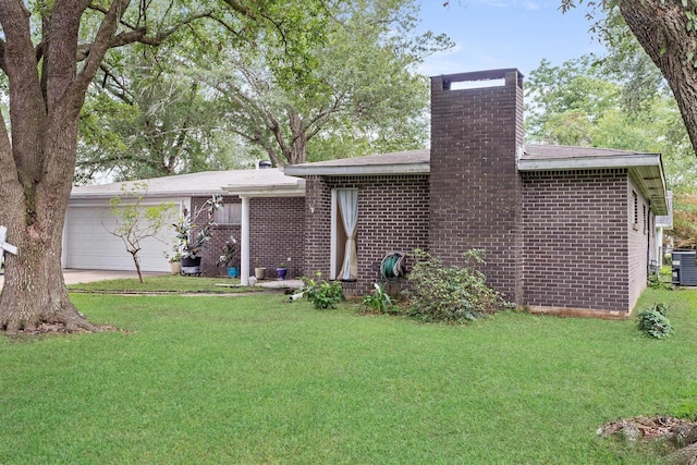 171 Ridgewood St, Bridge City, TX 77611 - view of front of house with a chimney, an attached garage, a front lawn, and driveway
