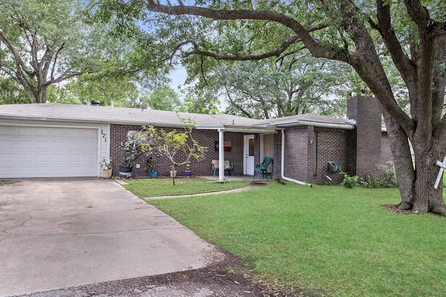 171 Ridgewood St, Bridge City, TX 77611 - view of front facade featuring driveway, a front lawn, an attached garage, and brick siding