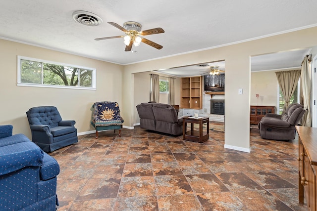 171 Ridgewood St, Bridge City, TX 77611 - living room featuring a ceiling fan, baseboards, ornamental molding, a brick fireplace, and stone finish flooring
