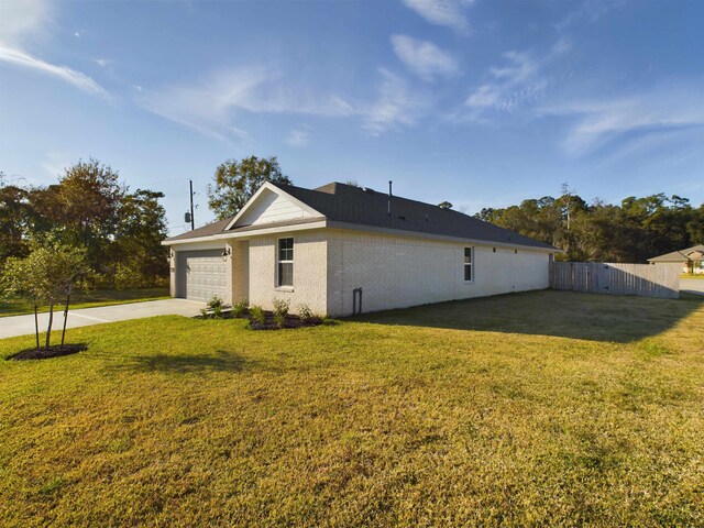 view of home's exterior featuring a garage and a yard