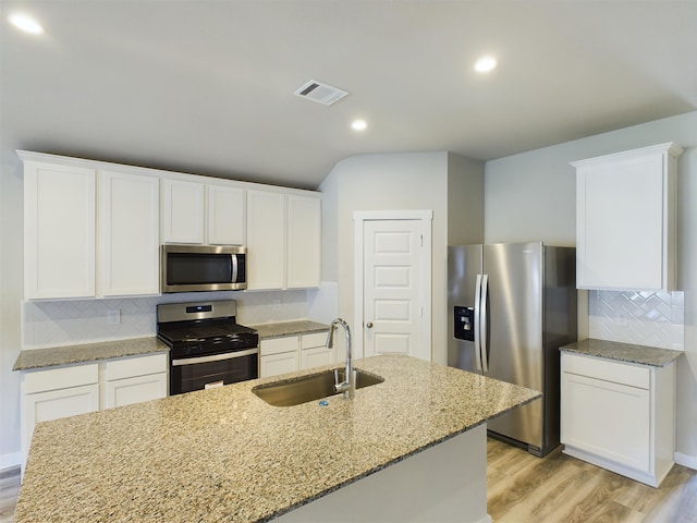 kitchen with white cabinets, sink, appliances with stainless steel finishes, and tasteful backsplash