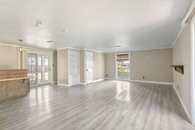 4438 W Edgar Ave, Orange, TX 77630 - unfurnished living room with plenty of natural light, light wood-style floors, and crown molding