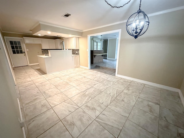 4438 W Edgar Ave, Orange, TX 77630 - kitchen featuring a chandelier, ornamental molding, backsplash, white cabinets, and open floor plan