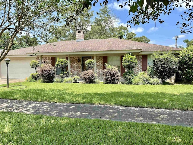 ranch-style house with a garage and a front lawn