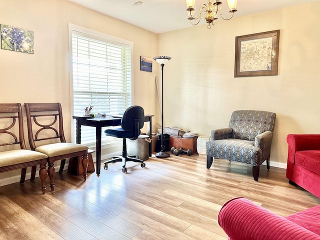 home office featuring light hardwood / wood-style flooring and a chandelier