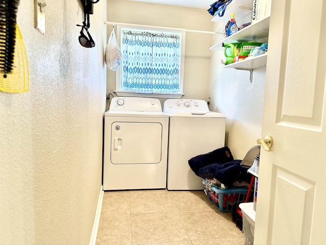 laundry room with light tile patterned floors and independent washer and dryer