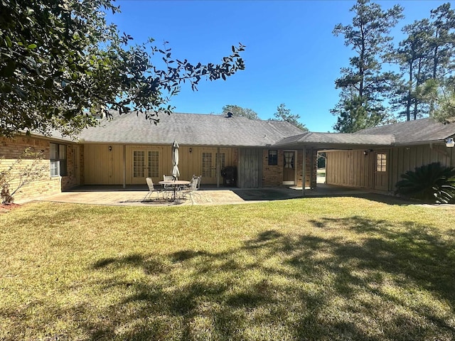 rear view of house featuring a yard and a patio