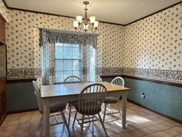 dining area featuring tile patterned flooring, crown molding, an inviting chandelier, and a textured ceiling