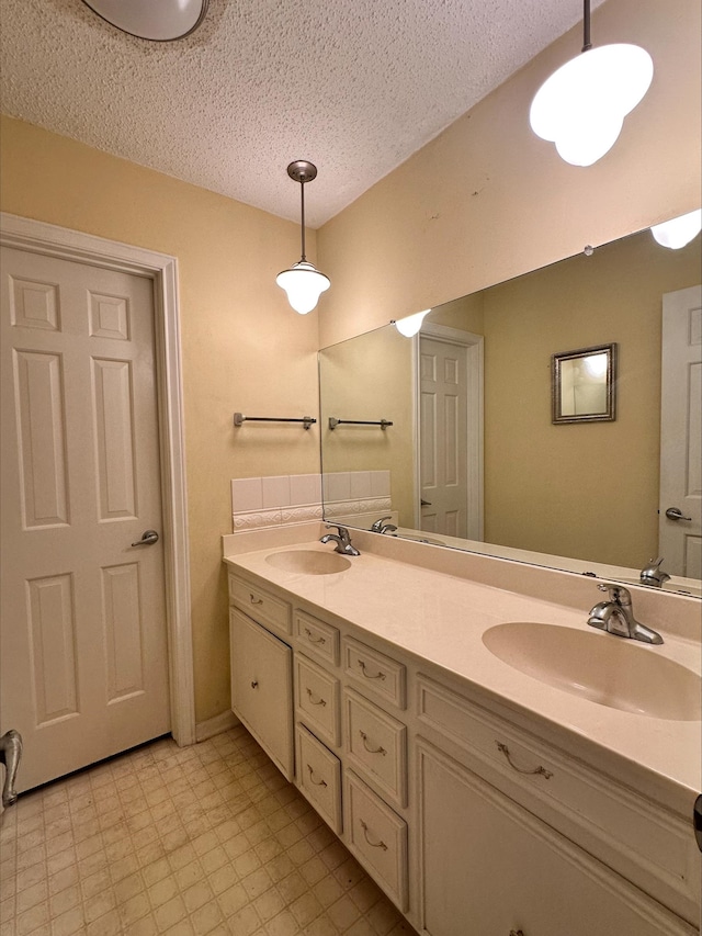 bathroom with vanity and a textured ceiling