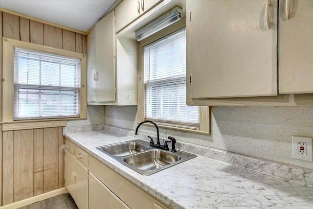 kitchen featuring cream cabinetry, plenty of natural light, and sink