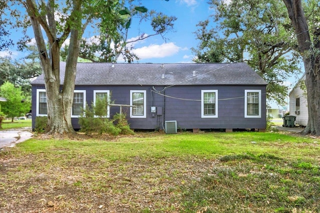 exterior space with a lawn and central AC