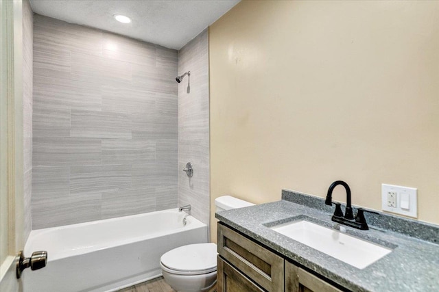 full bathroom featuring vanity, toilet, and tiled shower / bath