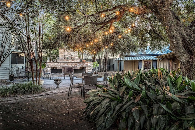 view of patio with an outdoor fireplace