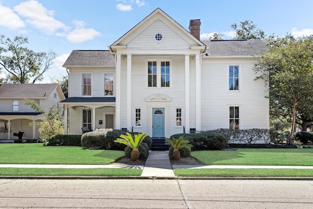 greek revival house with a front lawn