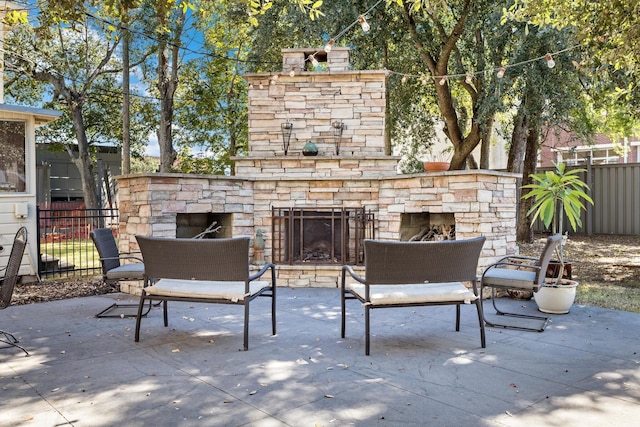 view of patio with an outdoor stone fireplace