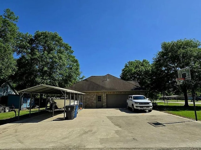 7090 Carroll Ln, Beaumont, TX 77713 - view of side of home with driveway, a garage, a carport, and a yard