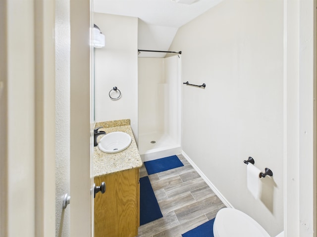 7090 Carroll Ln, Beaumont, TX 77713 - bathroom with walk in shower, vanity, and wood finished floors
