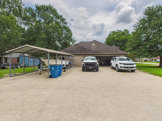 7090 Carroll Ln, Beaumont, TX 77713 - view of home's exterior with driveway, a carport, and a shed