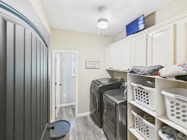 7090 Carroll Ln, Beaumont, TX 77713 - laundry area featuring cabinet space, washer and dryer, and light wood-type flooring
