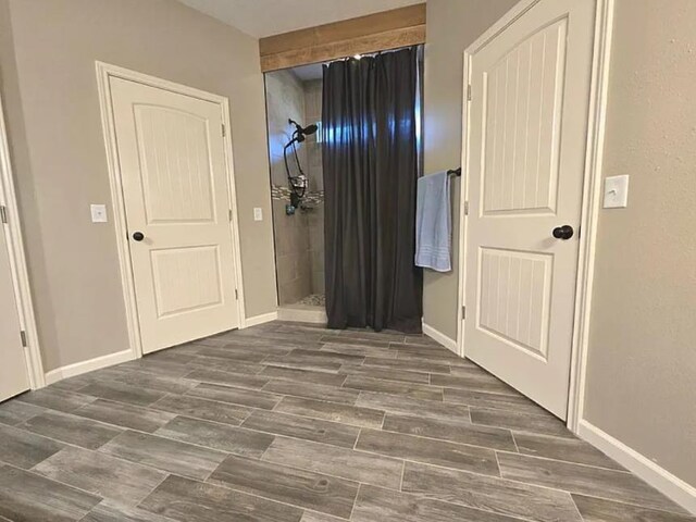 7090 Carroll Ln, Beaumont, TX 77713 - unfurnished bedroom with baseboards and wood finished floors