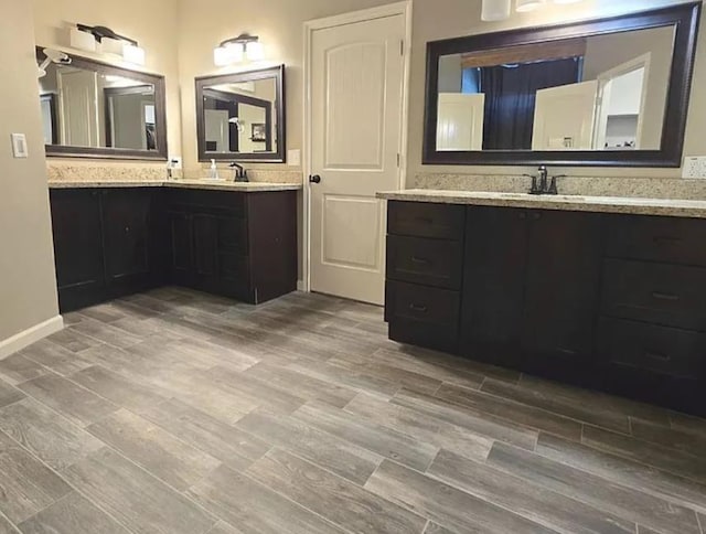7090 Carroll Ln, Beaumont, TX 77713 - full bathroom with two vanities and wood finished floors