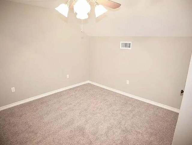 7090 Carroll Ln, Beaumont, TX 77713 - empty room featuring carpet, ceiling fan, baseboards, and vaulted ceiling