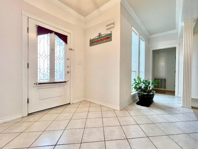 entryway with light tile patterned floors, visible vents, baseboards, and crown molding