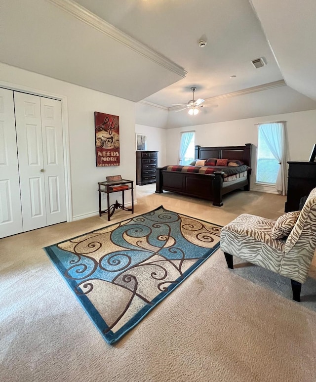 bedroom featuring crown molding, a closet, light colored carpet, visible vents, and a ceiling fan