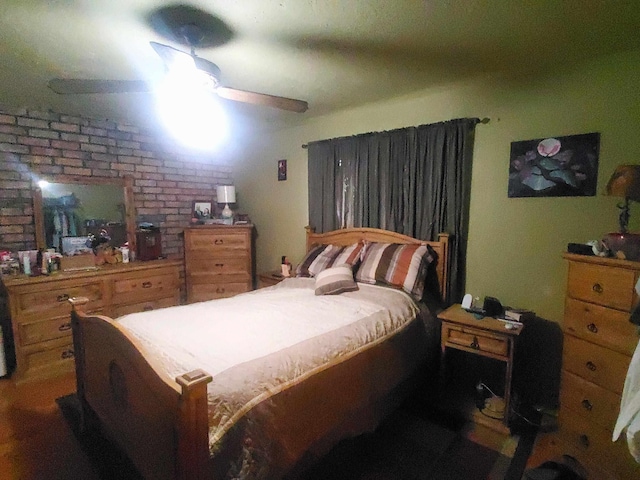 bedroom with brick wall and a ceiling fan