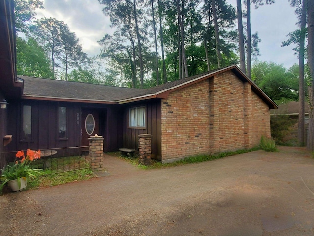 view of front facade with brick siding and board and batten siding