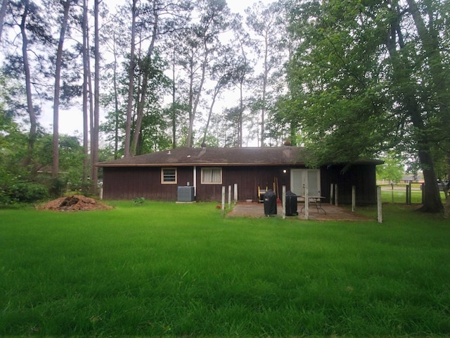 back of house with cooling unit, a patio area, a lawn, and fence