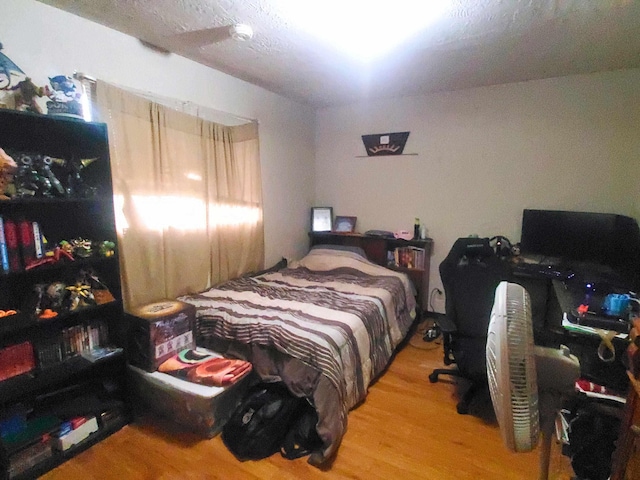 bedroom with wood finished floors