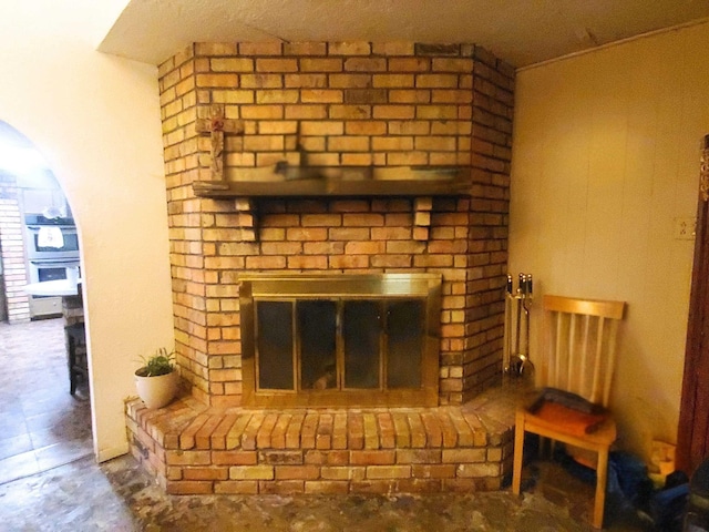 interior details featuring arched walkways and a fireplace