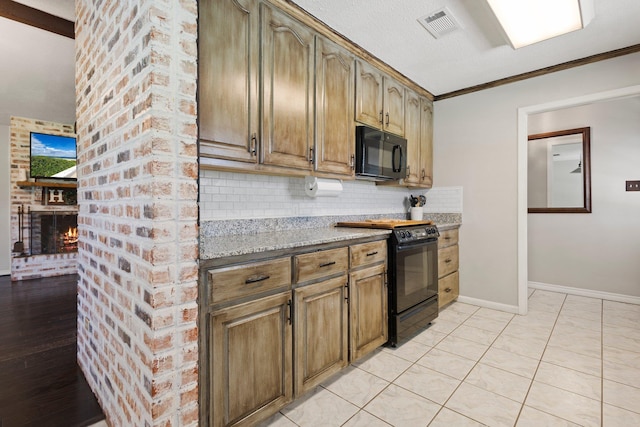4169 Leatherwood Dr, Kountze, TX 77625 - kitchen featuring black appliances, decorative backsplash, light stone countertops, a fireplace, and crown molding