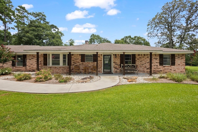 4169 Leatherwood Dr, Kountze, TX 77625 - ranch-style house with a front yard and brick siding