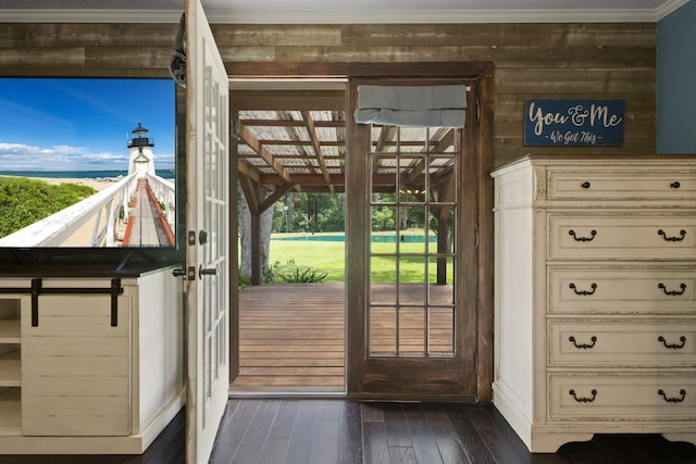 4169 Leatherwood Dr, Kountze, TX 77625 - doorway with crown molding, dark wood finished floors, and wooden walls