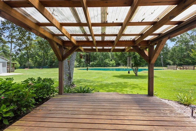 4169 Leatherwood Dr, Kountze, TX 77625 - wooden terrace featuring a yard and view of wooded area