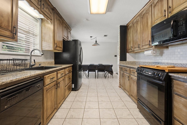 4169 Leatherwood Dr, Kountze, TX 77625 - kitchen featuring black appliances, decorative backsplash, and light tile patterned flooring