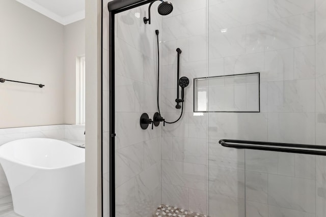 bathroom featuring ornamental molding and shower with separate bathtub