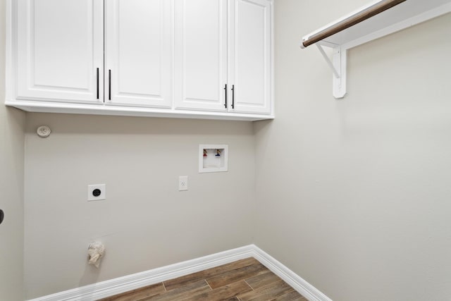 washroom with dark hardwood / wood-style flooring, cabinets, hookup for a washing machine, and hookup for an electric dryer