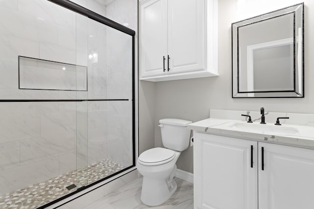 bathroom with vanity, toilet, and a shower with shower door