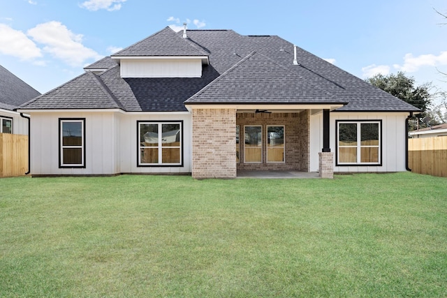 back of property featuring a lawn, a patio, and ceiling fan