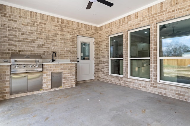 view of patio featuring ceiling fan, an outdoor kitchen, and a grill