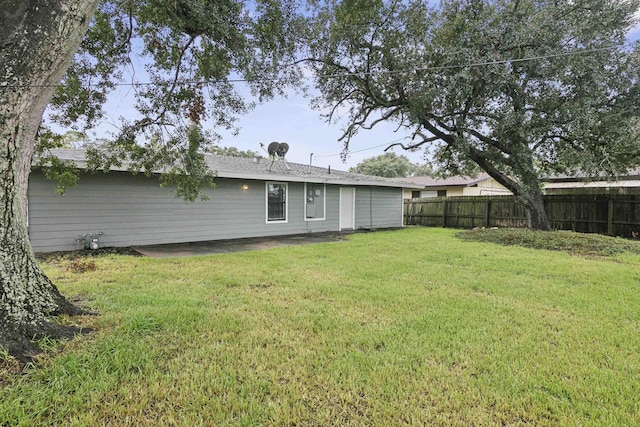 rear view of house with a yard