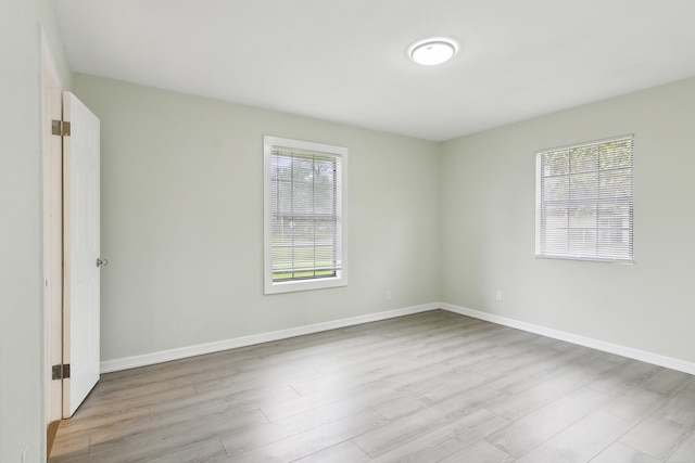 empty room featuring light hardwood / wood-style floors and a healthy amount of sunlight