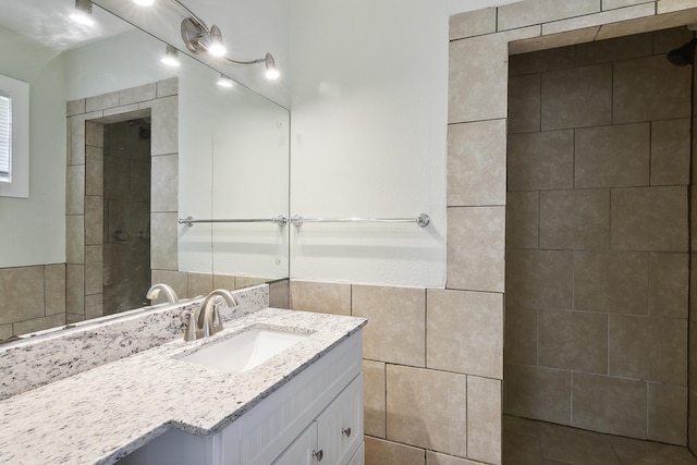 bathroom with tile walls and vanity